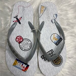 Michael Kors White Flip Flops with Gray Straps and Travel Patch Print